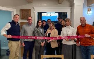 QPM team at showroom ribbon cutting