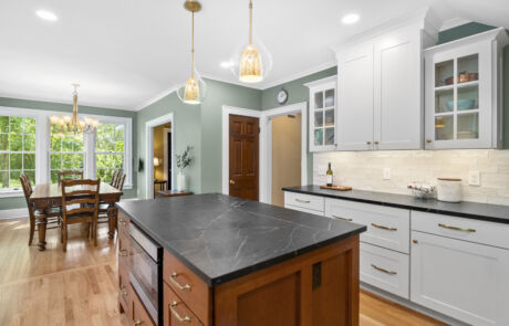 95BR – Kitchen – Full View Facing Cabinets, Island, and Dining Room